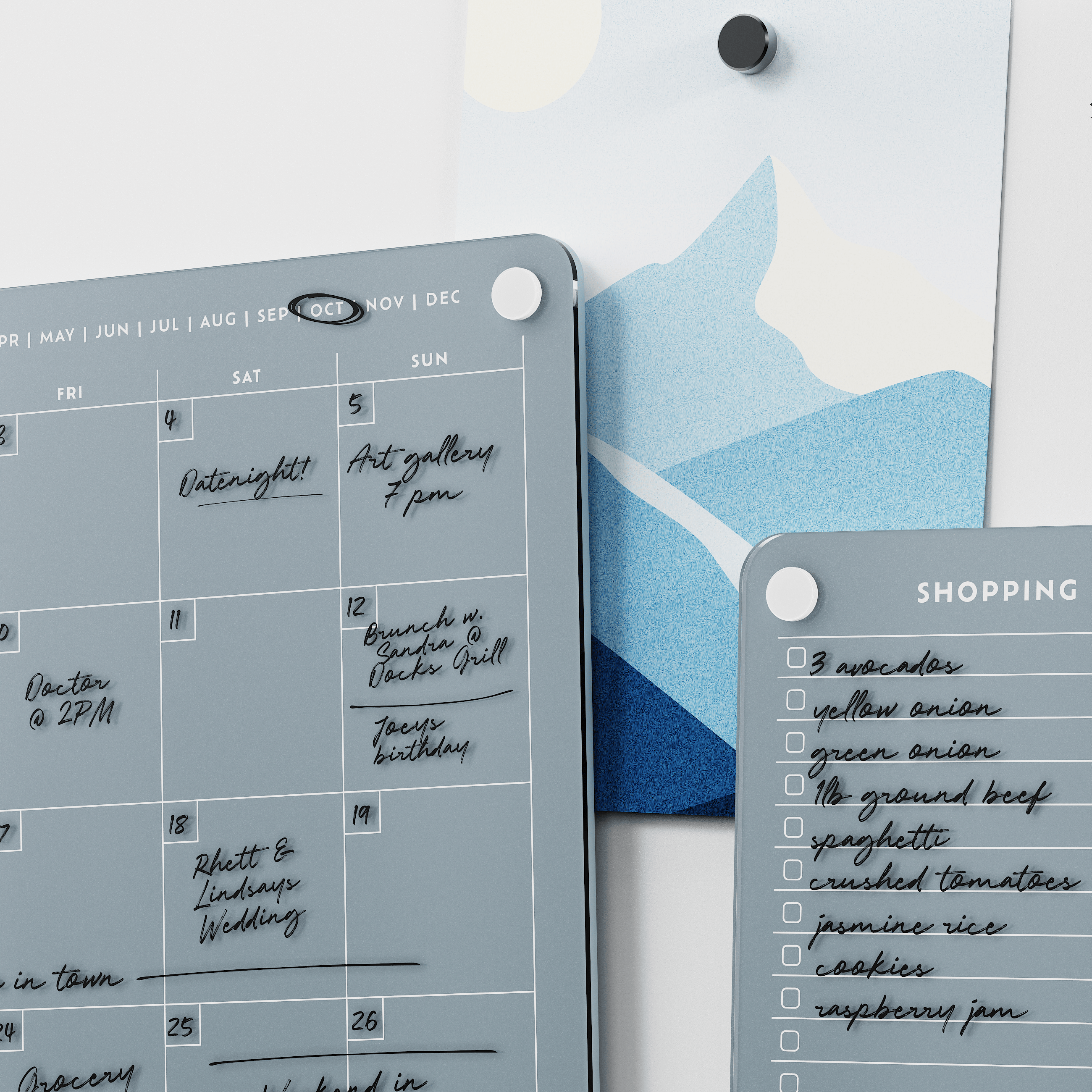 Close-up of the Slate grey monthly calendar and shopping list boards with handwritten plans and groceries